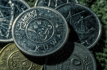 Coins of dinars, Kuwait national currency and lines from the Quran