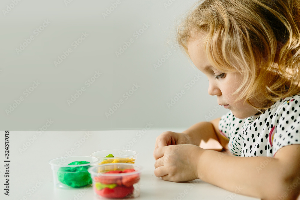 Wall mural the child is engaged in modeling on the table