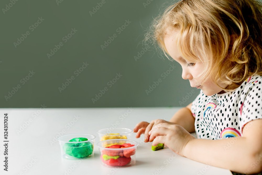 Wall mural the child is engaged in modeling on the table
