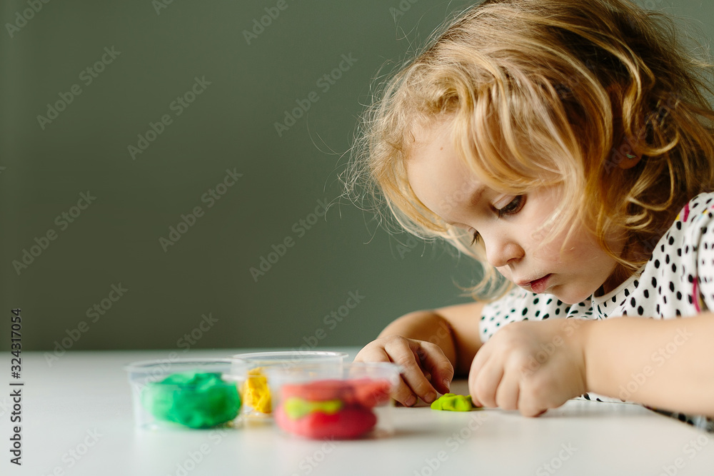 Wall mural the child is engaged in modeling on the table