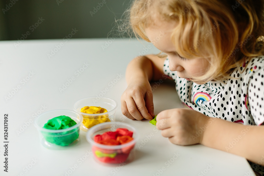 Wall mural the child is engaged in modeling on the table