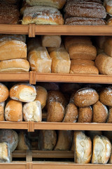 Shelves with loaves of freshly baked bread on display in bakery