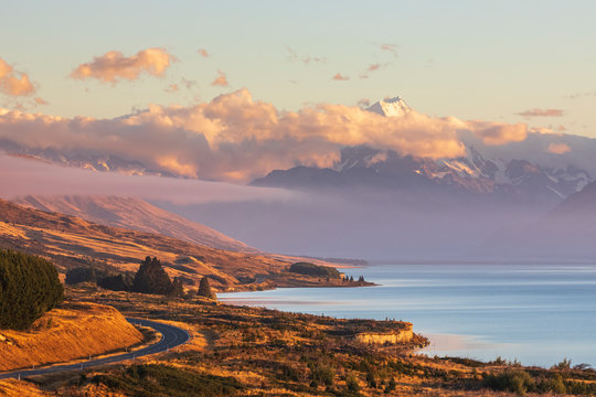 New Zealand, Scenic view of New†Zealand†State Highway 80 stretching along shore of Lake†Pukaki†at dawn with Mount Cook in background