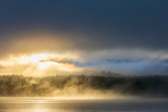 New Zealand, Oceania, South Island, Canterbury, Lake Tekapo with clouds and fog at sunset