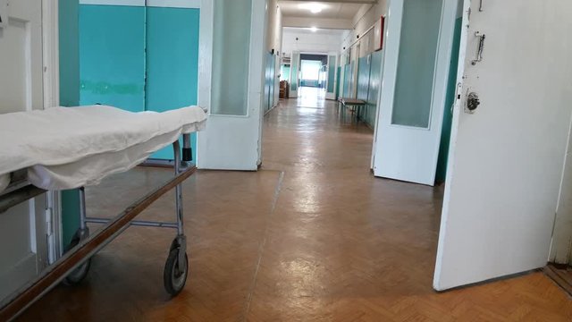 The corridor of the hospital. Wheelchair for transporting bedridden patients. Hospital and medical care concept