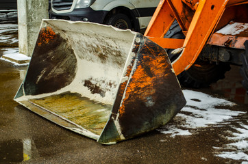 Yellow empty tractor loader bucket
