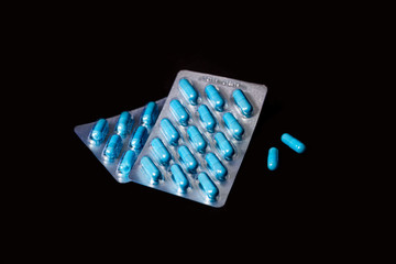 Two packages of blue capsules. Pills for men's health and sexual energy. Concept of erection,...