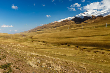 pylons of high-voltage power lines in the mountains, Kochkor District, Naryn region Kyrgyzstan