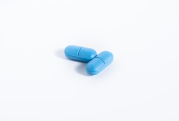 pharmaceutical industry concept, blue pills close-up on a white background