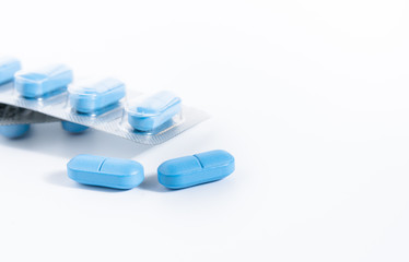 pharmaceutical industry concept, blue pills close-up on a white background