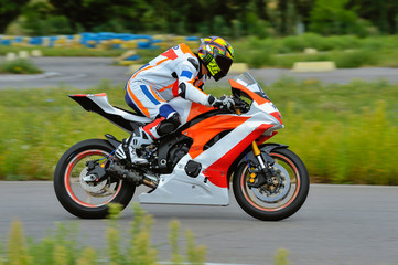 Motorcycle practice leaning into a fast corner on track