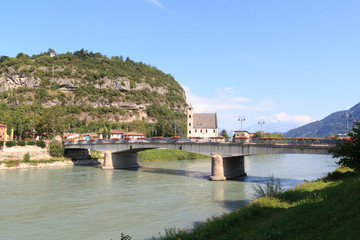 Fototapeta na wymiar River Adige, bridge, church Sant Apollinare and mountain alps panorama in Trento, Italy