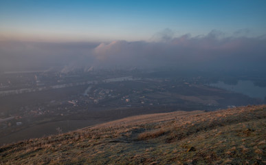 Sunrise time on Radobyl hill over valley of river Labe and Litomerice town