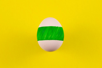 one colored egg on a yellow background. copyspace for text
