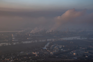 Sunrise time on Radobyl hill over valley of river Labe with big factory