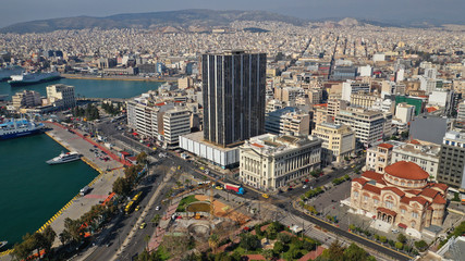 Fototapeta na wymiar Aerial drone photo of abandoned old public landmark skyscraper in famous busy port of Piraeus, Attica, Greece