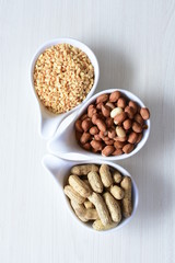 Dried peanuts (Arachis hypogaea) peanuts in shells, whole and chopped in containers