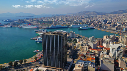 Aerial drone photo of abandoned old public landmark skyscraper in famous busy port of Piraeus,...