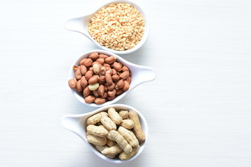 Dried peanuts (Arachis hypogaea) peanuts in shells, whole and chopped in containers