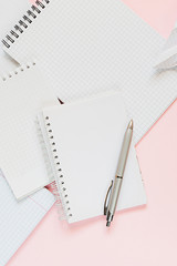 Top view of a flat lay of  desktop and notepads for writing down goals and plans. 2020 New Year's goal, plan, action text on  notepad with office accessories. Business motivation, inspiration concept.