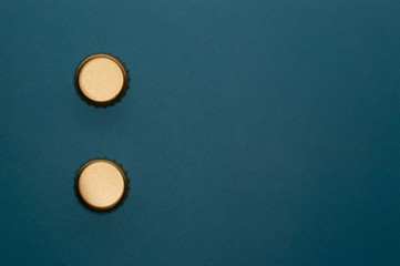 template of two bottle caps on blue background front