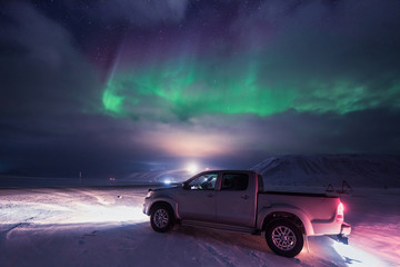 Fototapeta na wymiar The polar arctic Northern lights hunting aurora borealis sky star in Norway travel photographer man Svalbard in Longyearbyen city the moon mountains