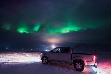 Fototapeta na wymiar The polar arctic Northern lights hunting aurora borealis sky star in Norway travel photographer man Svalbard in Longyearbyen city the moon mountains