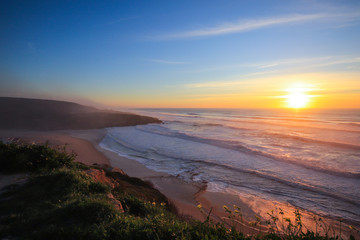 Amazing sunset in a beach with the ocean in background. 
