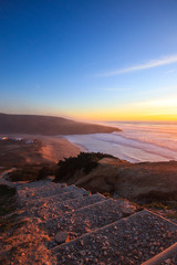 Amazing sunset in a beach with the ocean in background. 