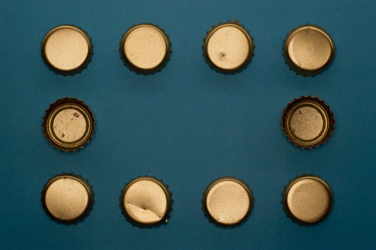 frame of bottle caps on blue background