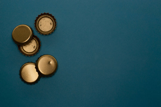 group of five bottle caps on blue background