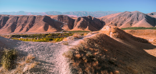 Panoramic view to the  valley within the Kopet Dag Mountains in background. Turkmenistan - obrazy, fototapety, plakaty