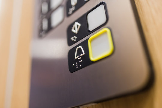 Close up of elevator alarm button on control panel. Emergency concept.