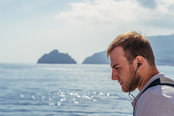 Headphones for listening to music. The guy listens to music through bluetooth headphones.