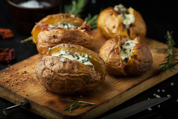 Baked potatoes with hamon and cheese in a pan