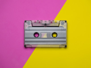 Retro cassettes on a yellow and pink background. view from above. copy space