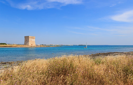 Picturesque Torre Chianca beach and historical fortification tower Torre Chianca (Torre Santo Stefano) on Salento Ionian sea coast, Porto Cesareo, Puglia, Italy.