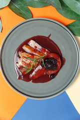 Gourmet beef tongue on mashed potatoes with tomatoes and rosemary. Bright colored background, creative concept of restaurant serving.