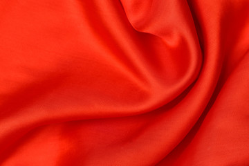Fototapeta na wymiar expensive fabric texture. abstract background with soft waves. Smooth elegant red silk or satin luxury cloth