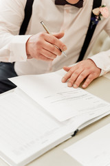 young man signs a marriage deed of marriage