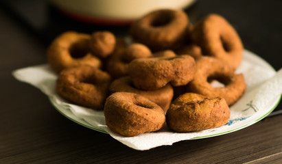 Fat Thursday home preparations - hand made doughnuts fried in deep oil in the kitchen, soaking off fat on the paper towel