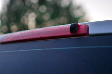 car brake light and rear window washer. close-up. copy space.