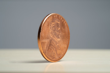 Money - Coins Lincoln Penny 2018 Angle View on wood with grey background