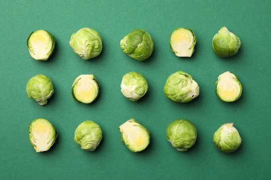 Flat lay with brussels sprout on green background, top view