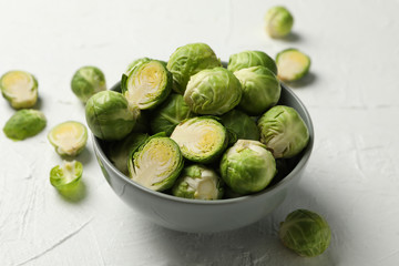 Bowl with brussels sprout on white background, close up