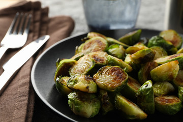 Composition with fried brussels sprout on grey background, close up