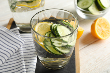 Composition with glasses of cucumber water on wooden background, close up