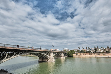 Fototapeta na wymiar View of the darsena of the Guadalquivir river in Seville with the Triana Bridge. Andalucia, Spain