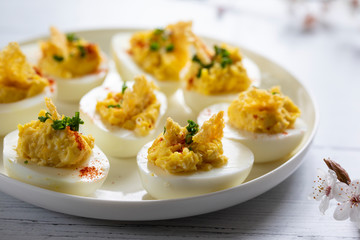 Devilled eggs canapes on the white plate