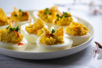 Devilled eggs canapes on the white plate